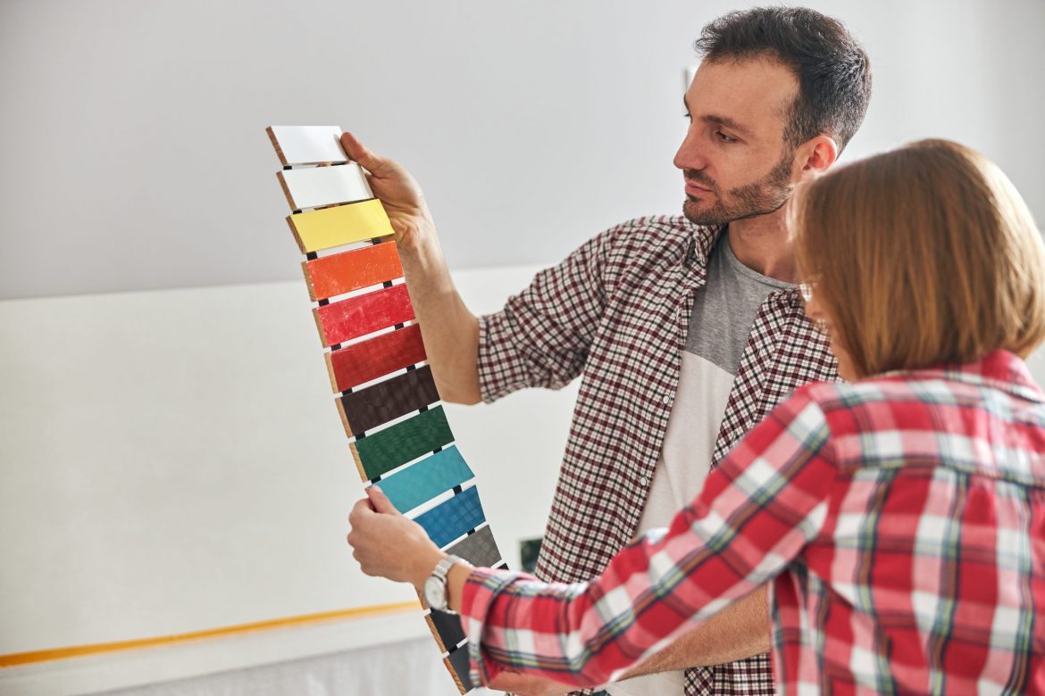 Worker and an apartment owner choosing the color palette